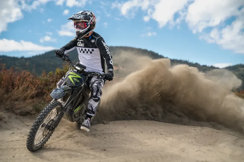 Rider on a Rawrr Mantis X Pro kicking up dust on a dirt track